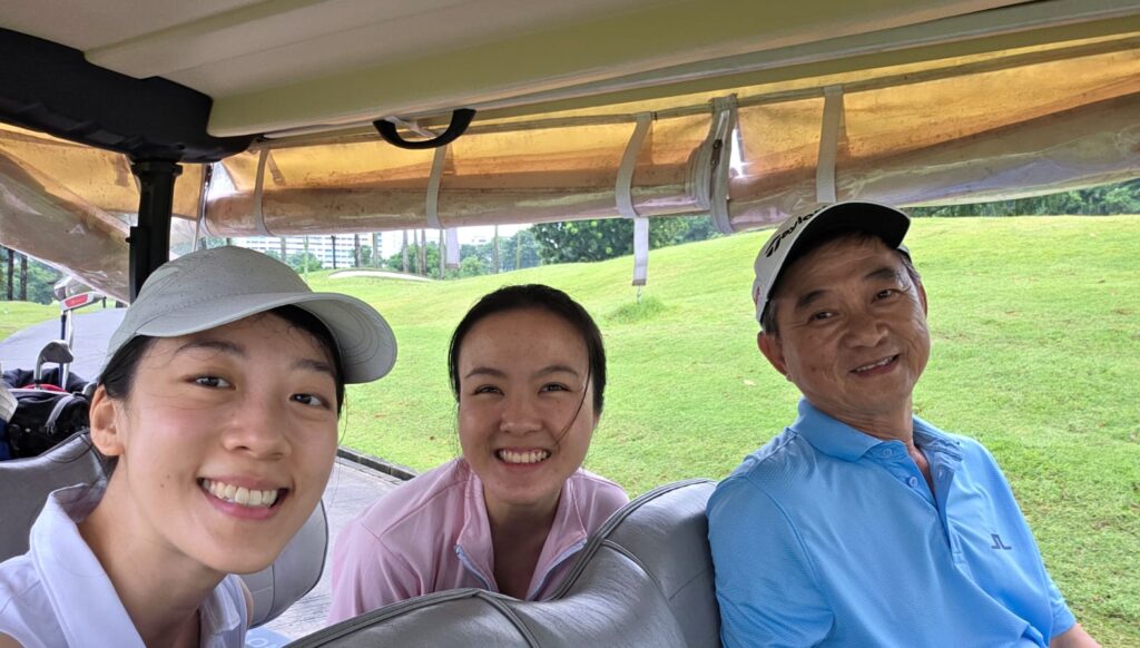 golfers smiling in a buggy or golf cart on the golf course during a lesson